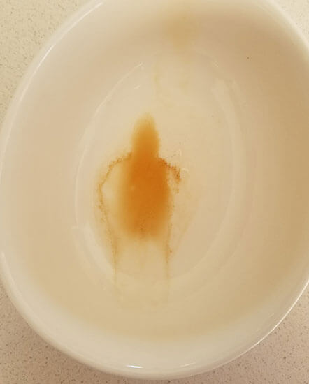 A photo of the alledge "Phantom of the Soy Sauce" shows a human-like figure within the last bits of soy sauce at the bottom of a small bowl.